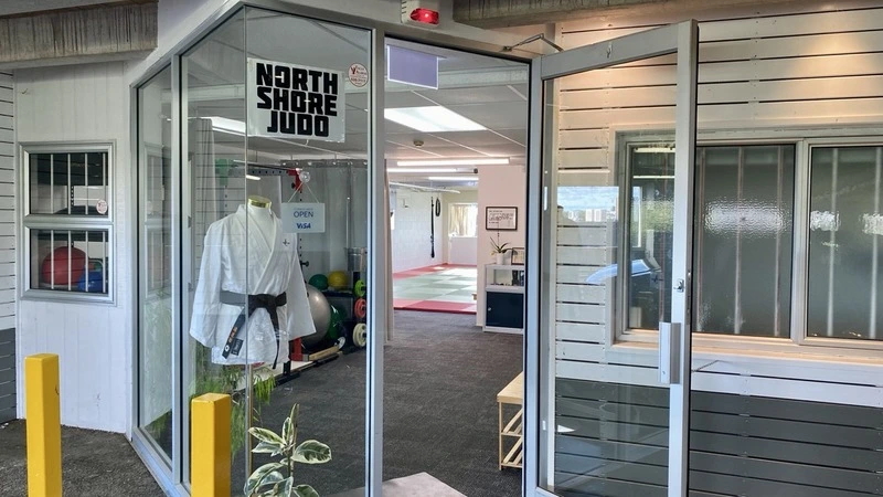 North Shore Judo’s entrance, with its sign on the open door and training mats inside